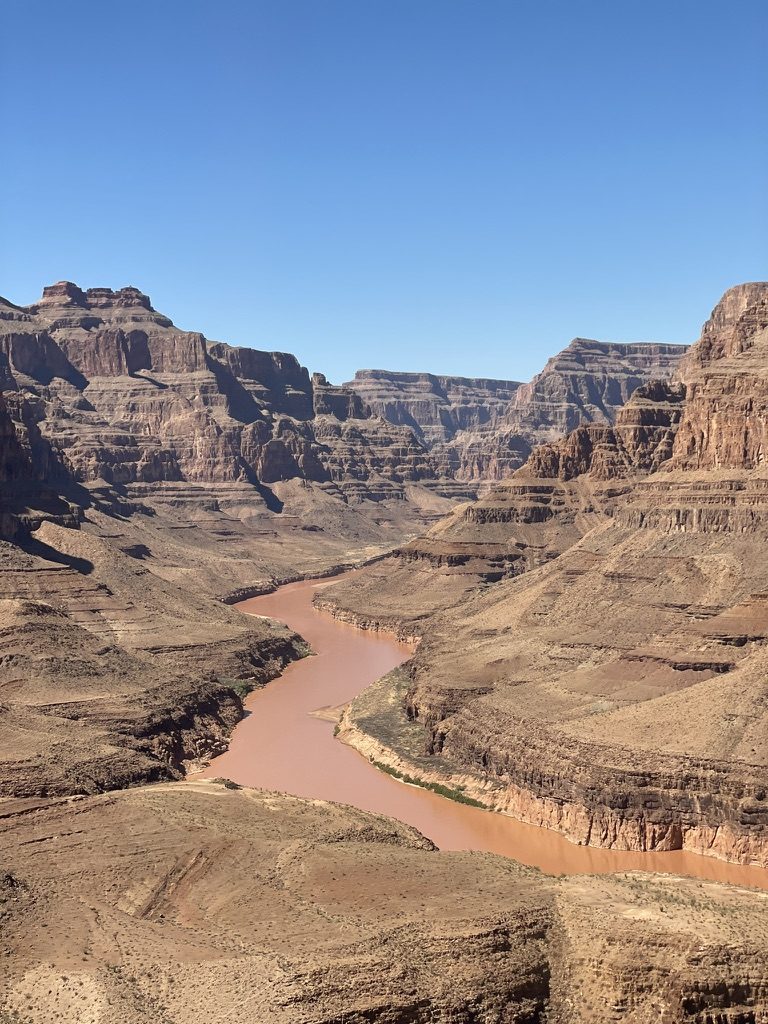 The Colorado River winding through red canyon walls