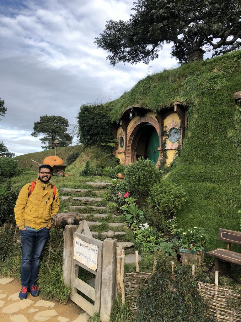 Standing outside a hobbit hole with a no admittance sign