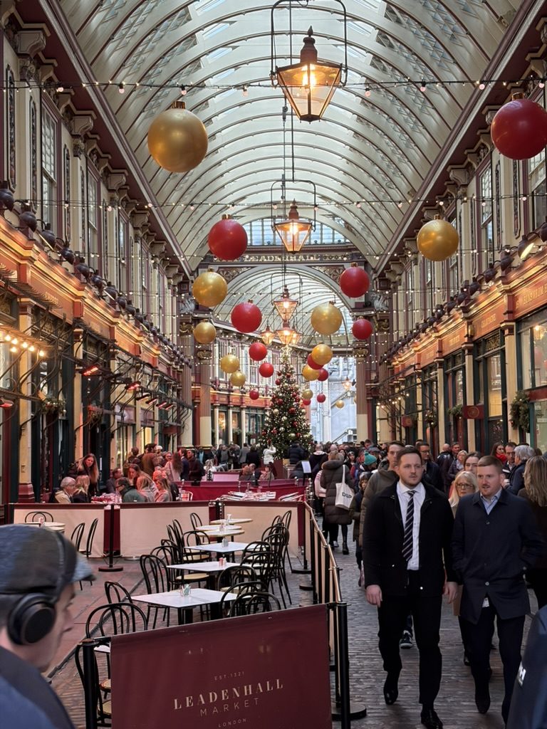 Leadenhall Market in London decorated with red and gold baubles at Christmas