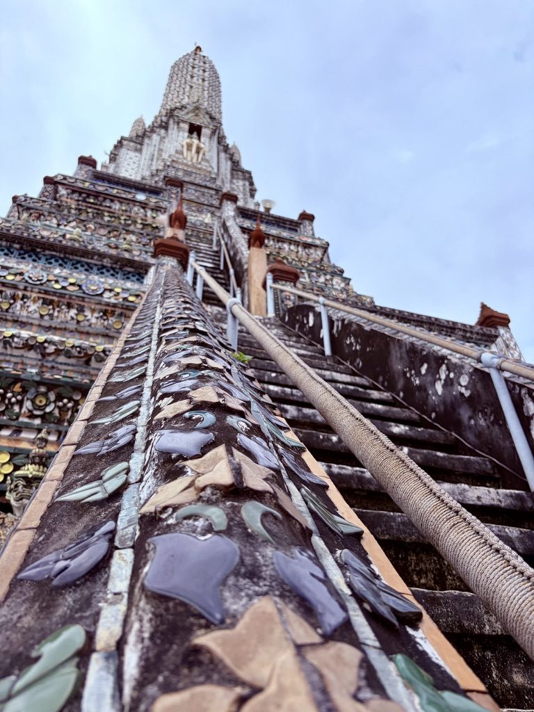 Looking up the steep stairs of Wat Arun, set with porcelain shards